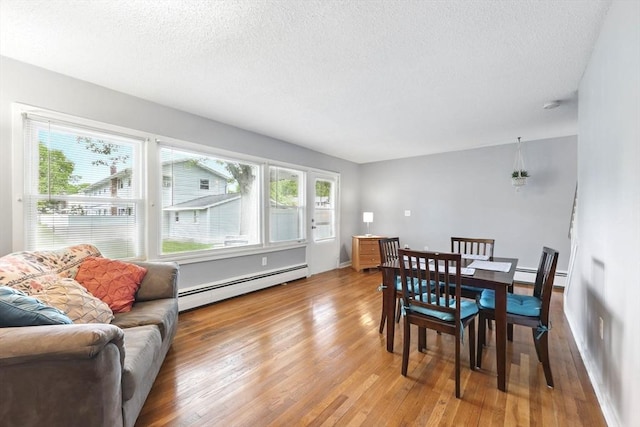 2500 Pendleton Ave Unit 2500, Chicopee, MA 01022 - dining space with a baseboard radiator, light wood finished floors, plenty of natural light, and a textured ceiling