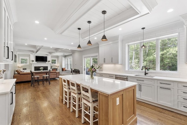 306 Laws Brook Rd, Concord, MA 01742 - kitchen featuring a sink, dishwasher, beam ceiling, open floor plan, and decorative backsplash