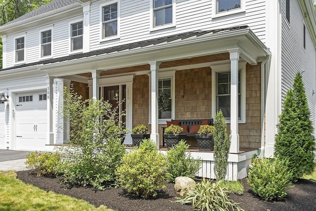 306 Laws Brook Rd, Concord, MA 01742 - property entrance featuring a porch, a standing seam roof, an attached garage, and metal roof
