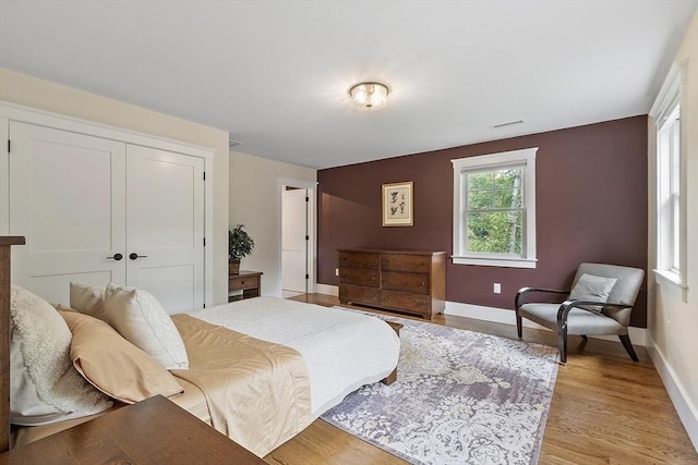 306 Laws Brook Rd, Concord, MA 01742 - bedroom with a closet, light wood finished floors, and baseboards