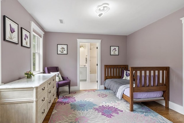 306 Laws Brook Rd, Concord, MA 01742 - bedroom featuring baseboards, wood finished floors, and connected bathroom