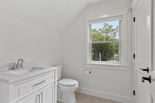 306 Laws Brook Rd, Concord, MA 01742 - half bathroom featuring vaulted ceiling, toilet, vanity, and baseboards