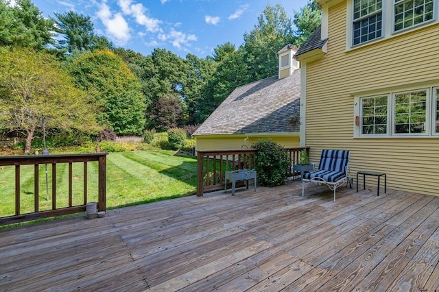 wooden terrace featuring a yard