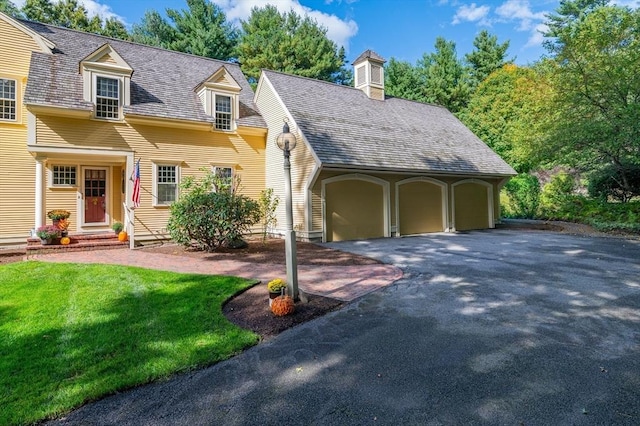 cape cod home with a front yard