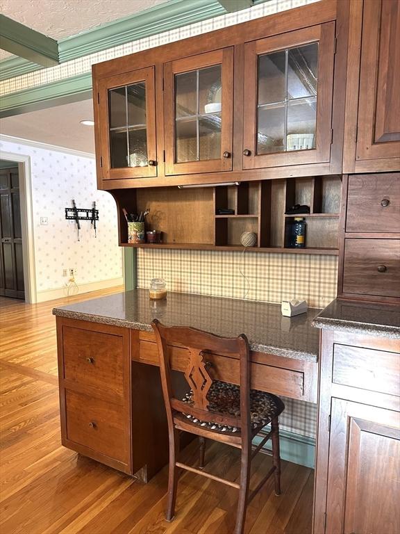 interior space with light hardwood / wood-style flooring and ornamental molding