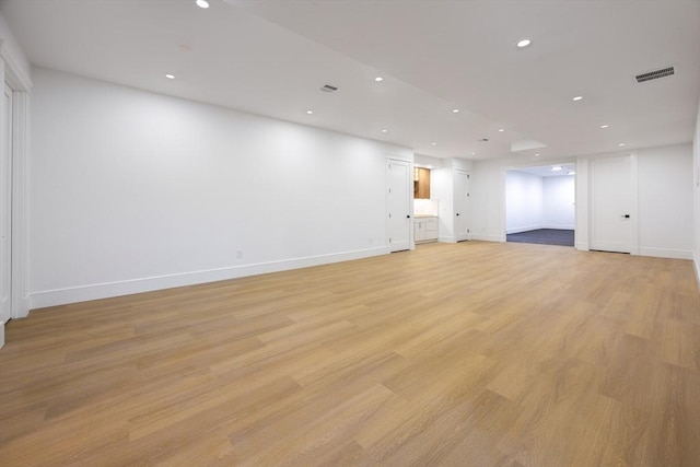 empty room with light hardwood / wood-style flooring