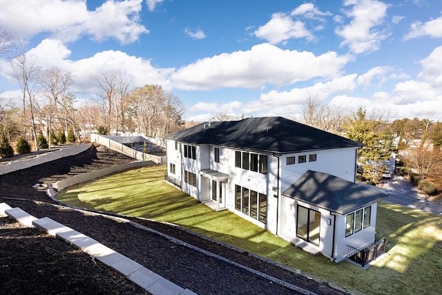 rear view of property featuring a yard