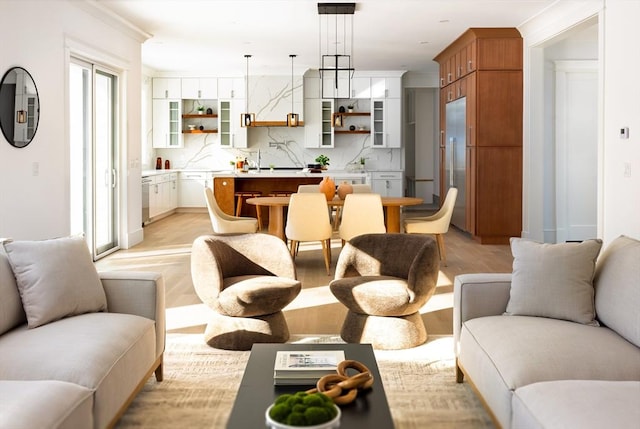 living room featuring light wood-type flooring and crown molding