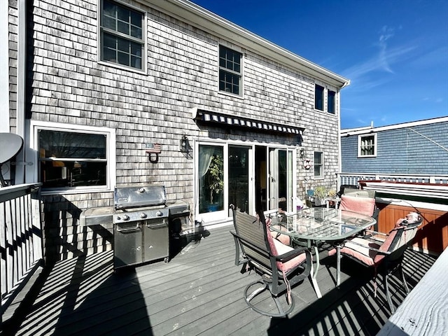 deck featuring a grill and outdoor dining area