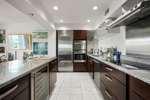 416 Commonwealth Ave Unit 504, Boston, MA 02215 - kitchen with appliances with stainless steel finishes, wine cooler, a sink, dark brown cabinetry, and light stone counters