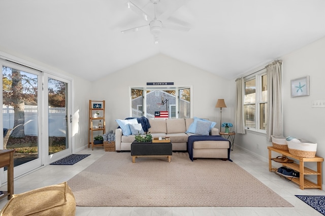 living room featuring plenty of natural light, lofted ceiling, light tile patterned floors, and ceiling fan