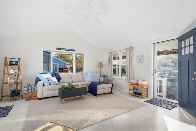 tiled living room with a wealth of natural light, lofted ceiling, and ceiling fan