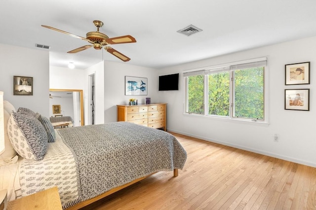 bedroom with wood finished floors, baseboards, and a ceiling fan