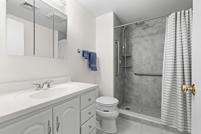full bath with a tile shower, toilet, vanity, and tile patterned flooring