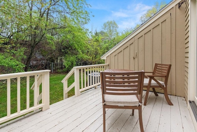 wooden terrace featuring outdoor dining area