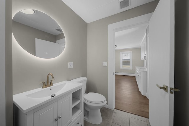 bathroom featuring tile patterned floors, visible vents, toilet, a baseboard radiator, and vanity