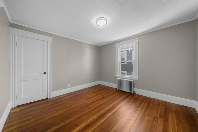 unfurnished room featuring crown molding, baseboards, radiator heating unit, and dark wood-type flooring