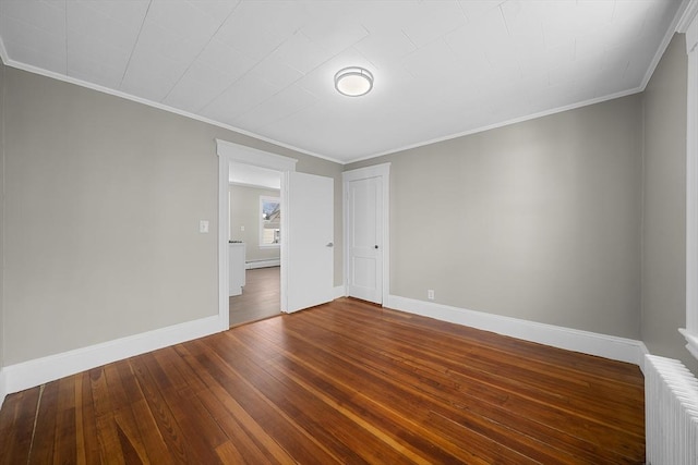 unfurnished room featuring baseboards, radiator, crown molding, and hardwood / wood-style flooring