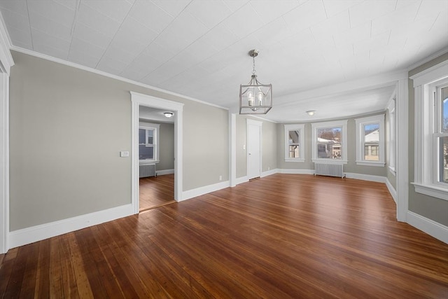 interior space with radiator, baseboards, wood-type flooring, and a chandelier