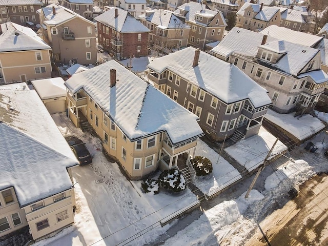 snowy aerial view featuring a residential view