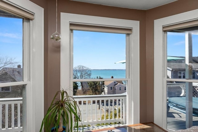 doorway to outside featuring a water view