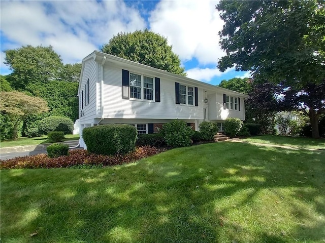 raised ranch with a front lawn