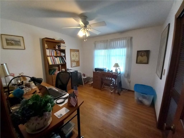 office with a ceiling fan and wood finished floors