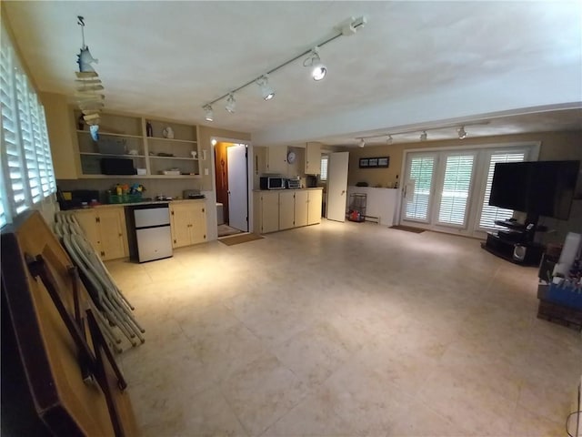 interior space featuring rail lighting and light floors