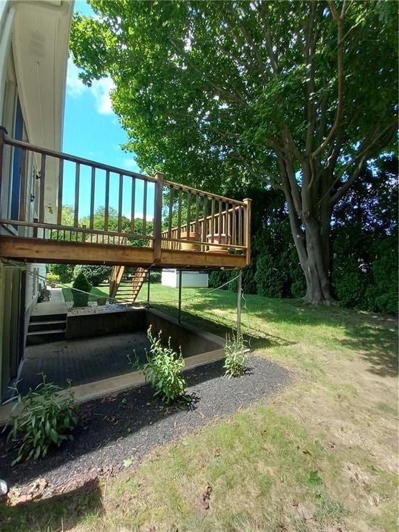 view of yard with stairs and a deck