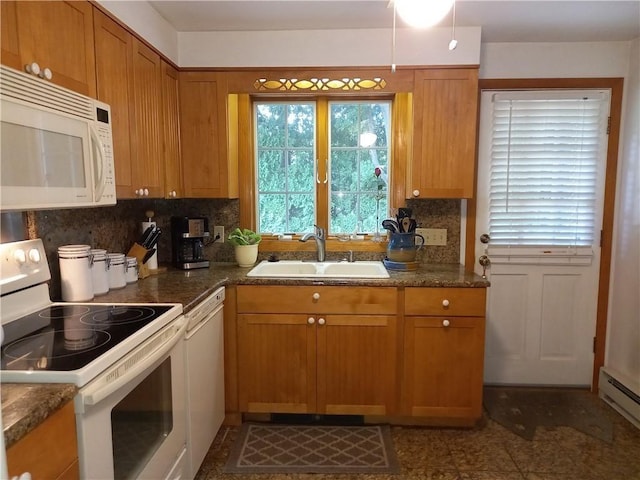 kitchen with a baseboard heating unit, white appliances, backsplash, brown cabinets, and a sink