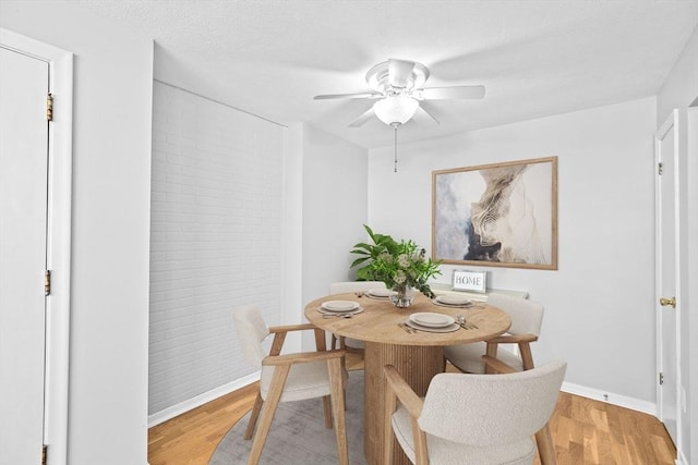 dining room with hardwood / wood-style flooring and ceiling fan