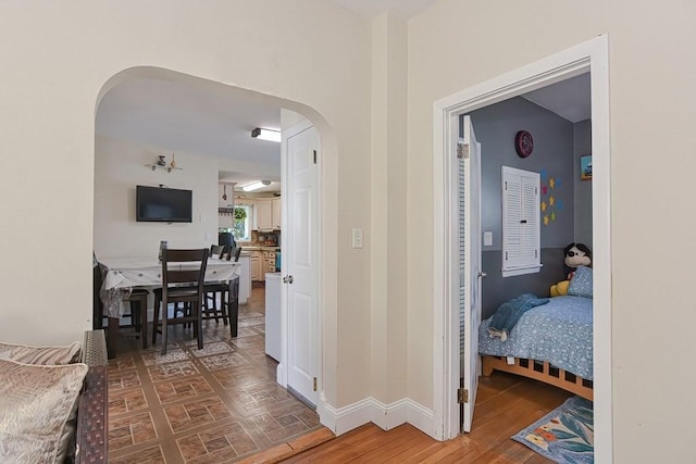 48 Tappan St, Everett, MA 02149 - hallway with arched walkways, wood finished floors, and baseboards