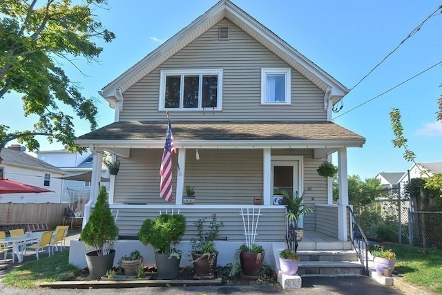 48 Tappan St, Everett, MA 02149 - view of front facade with a porch, fence, and roof with shingles