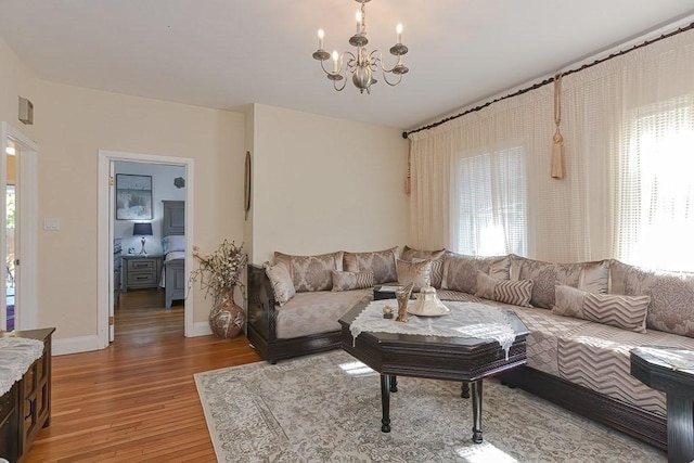 48 Tappan St, Everett, MA 02149 - living room with light wood finished floors, healthy amount of natural light, a chandelier, and baseboards