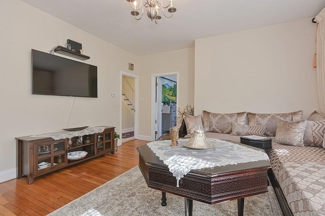 48 Tappan St, Everett, MA 02149 - living room featuring light wood-style flooring, stairway, baseboards, and a chandelier