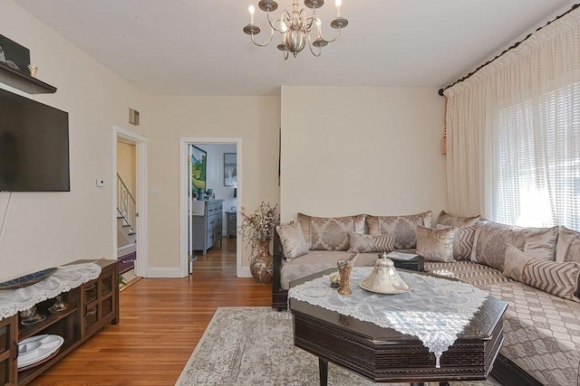48 Tappan St, Everett, MA 02149 - living area with a chandelier, stairway, and light wood-style flooring