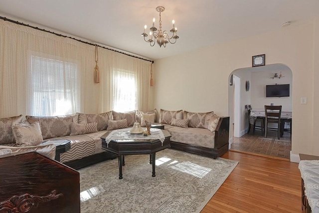 48 Tappan St, Everett, MA 02149 - living room with arched walkways, a chandelier, healthy amount of natural light, and wood finished floors