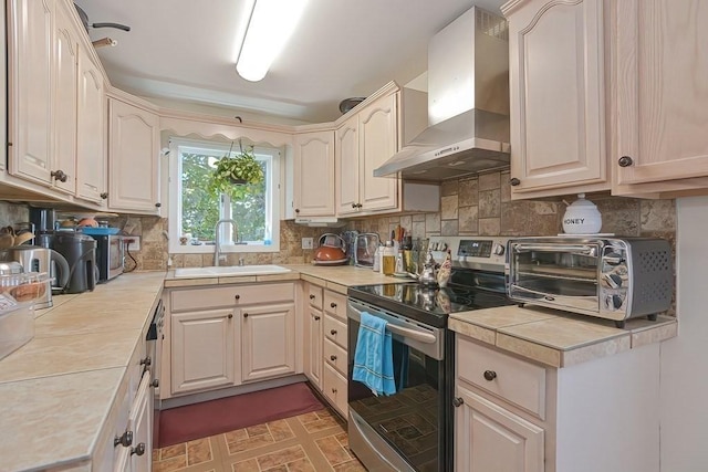 48 Tappan St, Everett, MA 02149 - kitchen with appliances with stainless steel finishes, wall chimney range hood, a sink, and tasteful backsplash