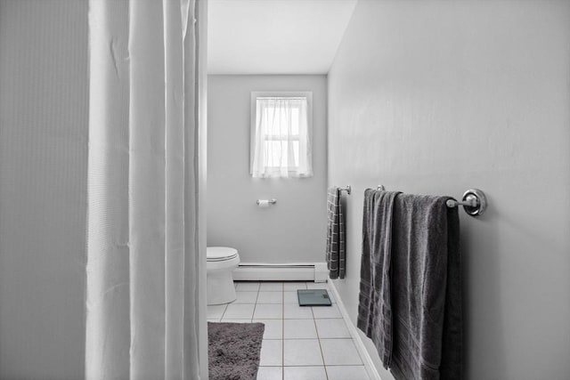 bathroom featuring baseboards, toilet, tile patterned floors, and baseboard heating