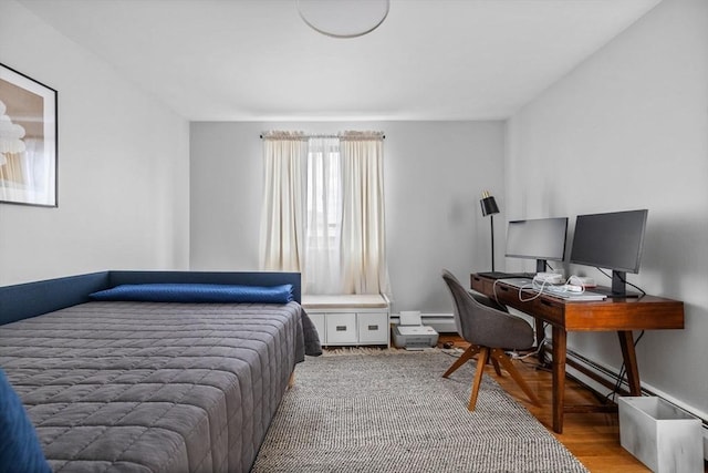 bedroom with baseboards and wood finished floors