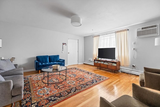 living room featuring baseboards, a baseboard radiator, wood finished floors, and a wall mounted air conditioner
