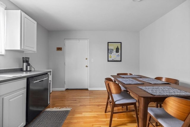 dining room with baseboards and light wood-type flooring