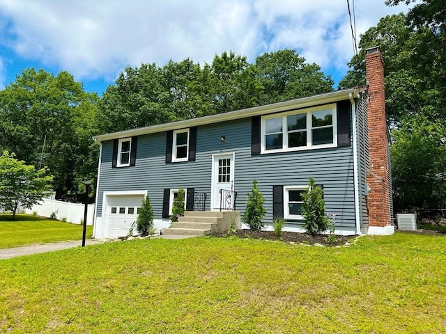17 Kingsley Rd, Norton, MA 02766 - bi-level home with a chimney, an attached garage, and driveway