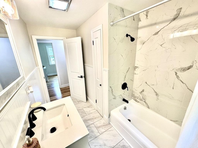 17 Kingsley Rd, Norton, MA 02766 - full bathroom featuring marble look tile flooring,  shower combination, vanity, and wainscoting
