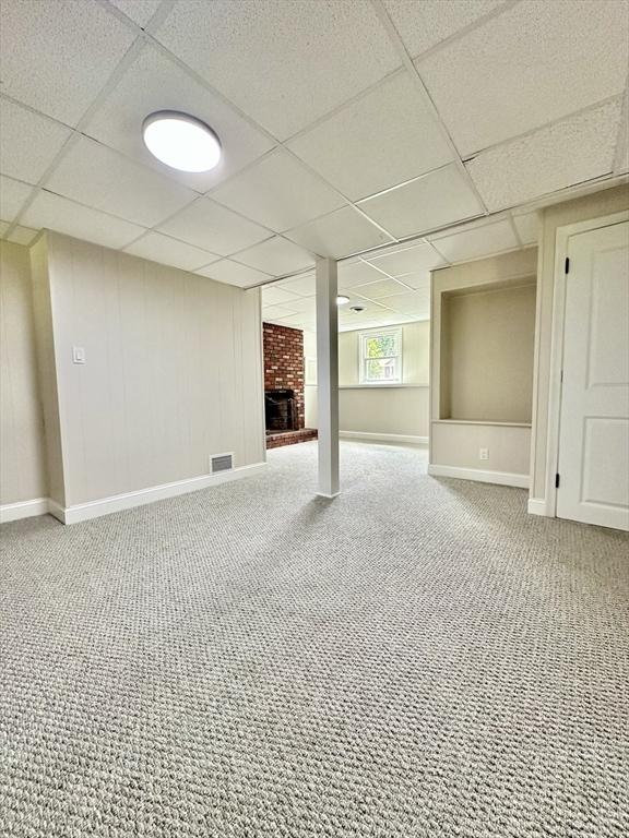 17 Kingsley Rd, Norton, MA 02766 - basement with a brick fireplace, a drop ceiling, and carpet