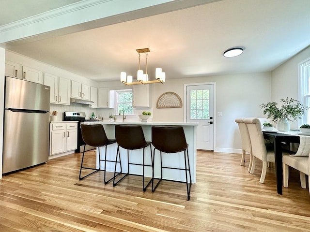 17 Kingsley Rd, Norton, MA 02766 - kitchen with appliances with stainless steel finishes, a breakfast bar, light wood-style flooring, and light countertops