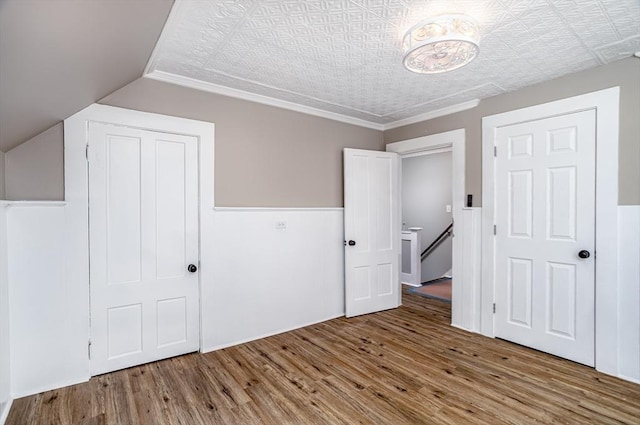 353 Front St, Winchendon, MA 01475 - unfurnished bedroom featuring wood finished floors, wainscoting, vaulted ceiling, and crown molding