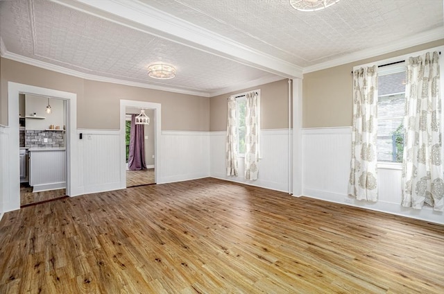 353 Front St, Winchendon, MA 01475 - spare room with hardwood / wood-style flooring, a wainscoted wall, and ornamental molding