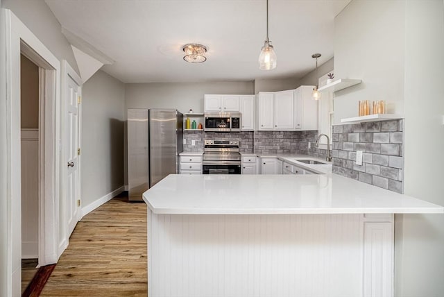 353 Front St, Winchendon, MA 01475 - kitchen with appliances with stainless steel finishes, open shelves, a peninsula, and tasteful backsplash
