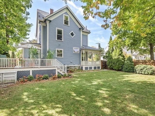 110 Woerd Ave, Waltham, MA 02453 - rear view of house with a deck and a chimney